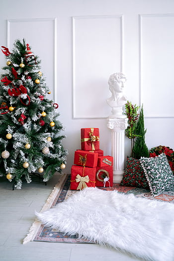 Festive room with Christmas tree, gifts, and classical decor for holiday ambiance. HD phone wallpaper