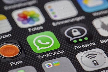 Detailed macro of smart screen showcasing popular app icons like WhatsApp. HD wallpaper