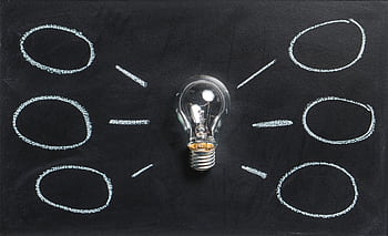 A lightbulb on a chalkboard symbolizes creativity, innovation, and ideas. HD wallpaper