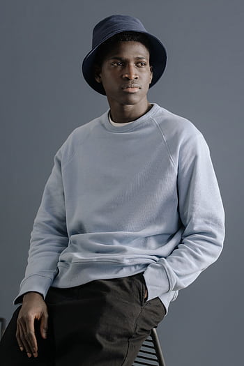 Portrait of a stylish man in casual clothing against a neutral background, exuding a relaxed and fashionable vibe. HD phone wallpaper