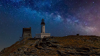Landscape View Of Lighthouse On Rock Under Starry Blue Sky During Nighttime Nature HD wallpaper