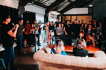 Vibrant business seminar in São Paulo with a diverse audience engaged in a speaker's presentation. HD wallpaper
