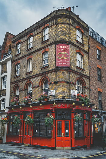 Quaint street view of the Golden Eagle pub's classic brick facade in London, England. HD phone wallpaper