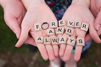 Hands holding 'forever and always' in Scrabble letters, symbolizing eternal love. HD wallpaper