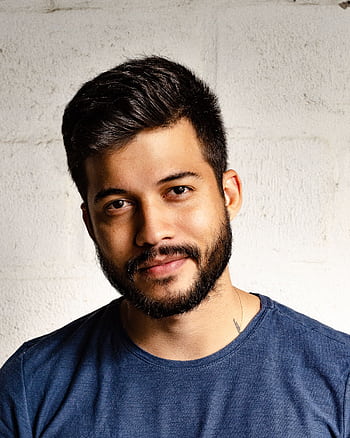 Close-up portrait of a handsome man with a beard in casual attire, smiling warmly. HD phone wallpaper