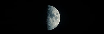 High-resolution of a half moon against a dark sky, showcasing lunar details. HD wallpaper