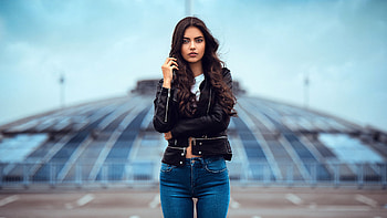 Beautiful Laura Theresa Girl Model Is Posing For A Standing In Blur Background Wearing Black Leather Jacket And Blue Jeans Girls HD wallpaper