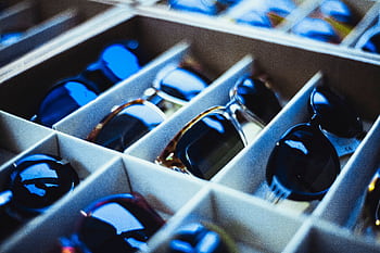 Close-up view of assorted sunglasses neatly arranged in display racks. HD wallpaper