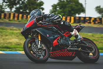 Exciting motorcycle race captured at high speed on a professional track. HD wallpaper