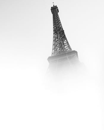 A foggy view of the Eiffel Tower emerging from the mist, capturing its iconic structure in a minimalist style. HD phone wallpaper