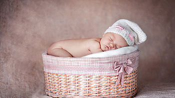 Cute Baby Boy Is Sleeping Inside Bamboo Basket Wearing White Woolen Knitted Cap In Blur Background Cute HD wallpaper