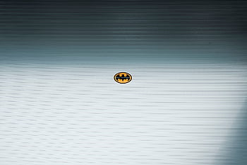 A minimalist Batman logo on a metallic roll-up door in daylight, Shilin District, Taipei. HD wallpaper