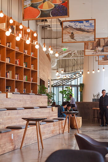 Elegant modern workspace in Ho Chi Minh City with bookshelves and pendant lighting. HD phone wallpaper