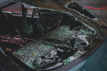 Detailed view of shattered car windshield after accident, emphasizing damage and broken glass. HD wallpaper