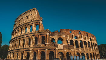 Stunning view of the ancient Roman Colosseum in Rome, Italy, captured at sunset showcasing its historic arches. HD wallpaper