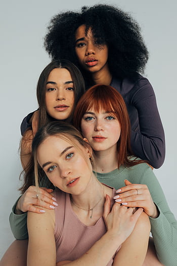 Portrait of a diverse group of women in fashionable attire, posing together. HD phone wallpaper
