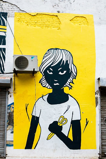 Colorful street art mural depicting a figure with scissors on a bright yellow wall in Delhi, India. HD phone wallpaper