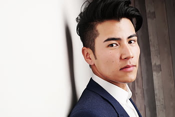 Close-up portrait of a serious Asian man in a formal suit indoors. Modern and professional look. HD wallpaper