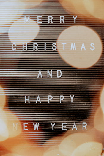 Christmas and New Year message on a festive bokeh background with warm tones. HD phone wallpaper