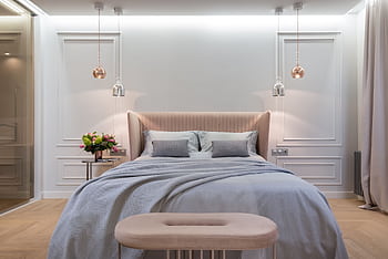 A modern and luxurious bedroom with elegant decor and lighting, featuring a plush bed and tasteful furnishings. HD wallpaper