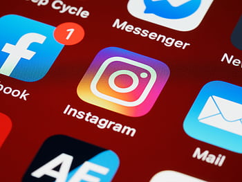 Vibrant close-up of popular social media app icons on a smart screen. HD wallpaper