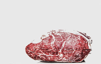 Premium raw beef piece displayed on a white background, perfect for culinary projects. HD wallpaper