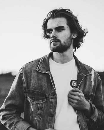 Artistic black and white portrait of a man in denim with expressive pose. HD phone wallpaper