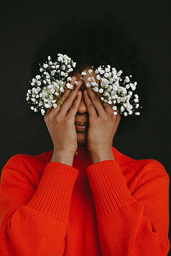 Artistic portrait of a woman covering her eyes with white flowers, against a dark background. HD phone wallpaper