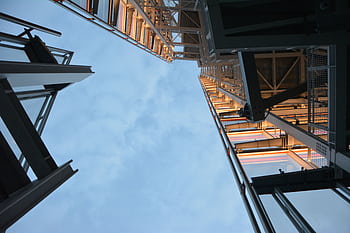 Low angle shot of modern steel structure reaching into the sky, daytime. HD wallpaper
