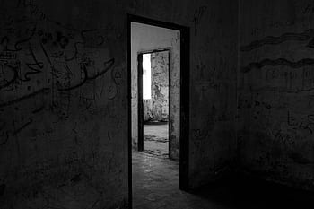 Dark, abandoned building interior with eerie shadows and graffiti-covered walls. HD wallpaper