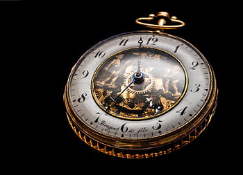 Close-up of a vintage gold pocket watch showcasing intricate gears on a black backdrop. HD wallpaper