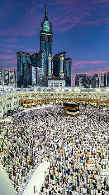 A breathtaking aerial view of the Kaaba in Mecca surrounded by worshippers, capturing the spirit of Hajj. HD phone wallpaper