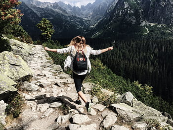 Woman hikes along rocky path in Vysoké Tatry, Slovakia. Embracing nature and dom. HD wallpaper
