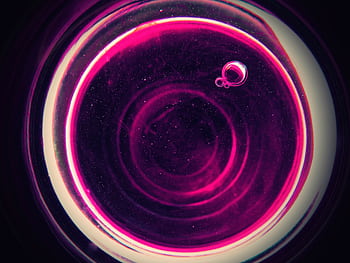 Vibrant abstract pink bubbles forming a circular pattern against a dark background, creating a cosmic feel. HD wallpaper