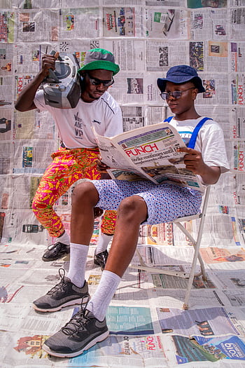 Two stylish men in Nigeria enjoying a sunny day with vintage style and flair. HD phone wallpaper