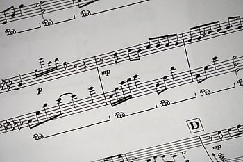Close-up of a detailed musical sheet showcasing notes and symbols in black and white. HD wallpaper