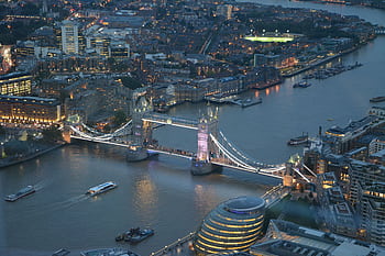 A stunning aerial graph capturing London's Tower Bridge illuminated at night over the Thames River. HD wallpaper