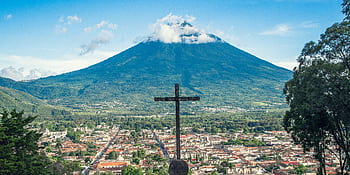 Scenic view of Antigua Guatemala with Volcán de Agua, featuring a prominent cross in the foreground. HD wallpaper