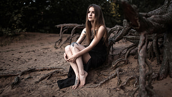 Beautiful Girl Model With Tattoos On Body Is Sitting In Blur Forest Background Wearing Black Dress Girls HD wallpaper