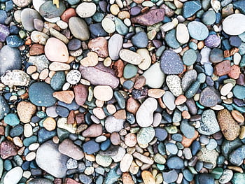 Vibrant collection of smooth, multicolored pebbles and stones arranged closely. HD wallpaper