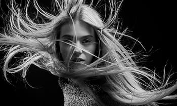 Captivating black and white portrait of a woman with flowing hair, artistic and stylish. HD wallpaper