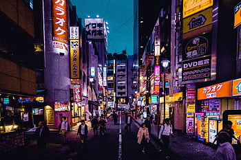 Explore the lively streets of Shinjuku, Tokyo at night with colorful lights and bustling activity. HD wallpaper