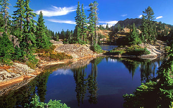 lake in the hills, hills, grass, rocks, lake, trees, nature, sky, water, forest HD wallpaper