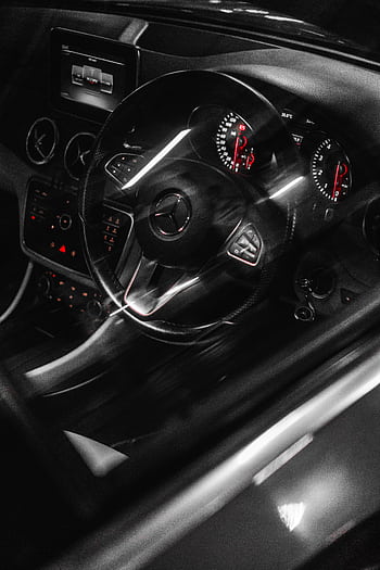 Close-up of a modern Mercedes-Benz car interior showcasing the dashboard and steering wheel in a luxury setting. HD phone wallpaper