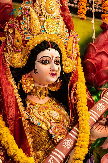 Vibrant idol of Goddess Durga adorned with colorful decorations during Navratri in India. HD phone wallpaper
