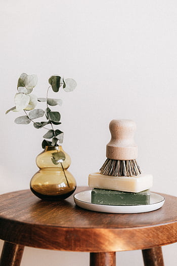 Minimalist composition of a shaving brush, soap, and eucalyptus on a wooden table. HD phone wallpaper
