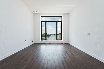 Spacious modern room with wooden floor and large window showcasing a scenic outdoor view. HD wallpaper