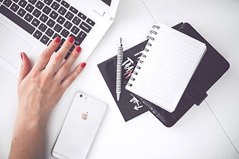 A minimalist workspace featuring a laptop, notebook, and smart from a top view. HD wallpaper