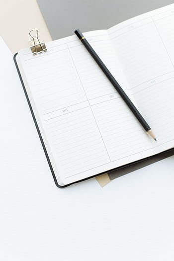 High-angle view of an open notebook with a pencil, perfect for planning or note-taking. HD phone wallpaper