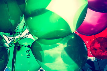 Colorful green and pink balloons captured in close-up for a festive celebration. HD wallpaper